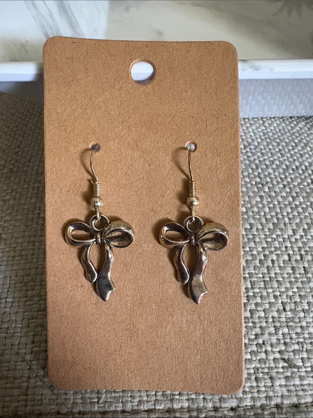 Bow Shaped Dangle Earrings in Metallic Gold
